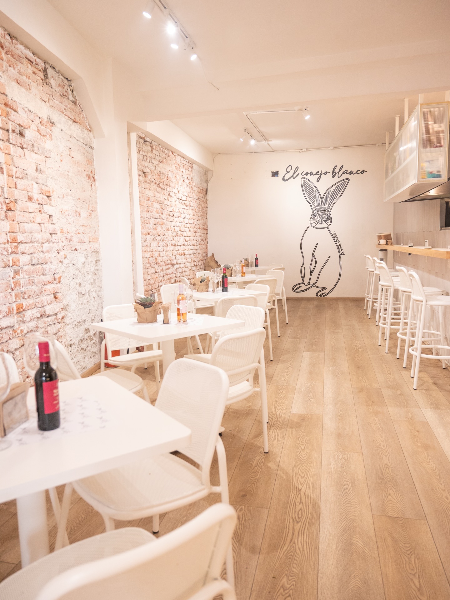 Conejo Blanco Café — warm interior with exposed brick and rabbit mural