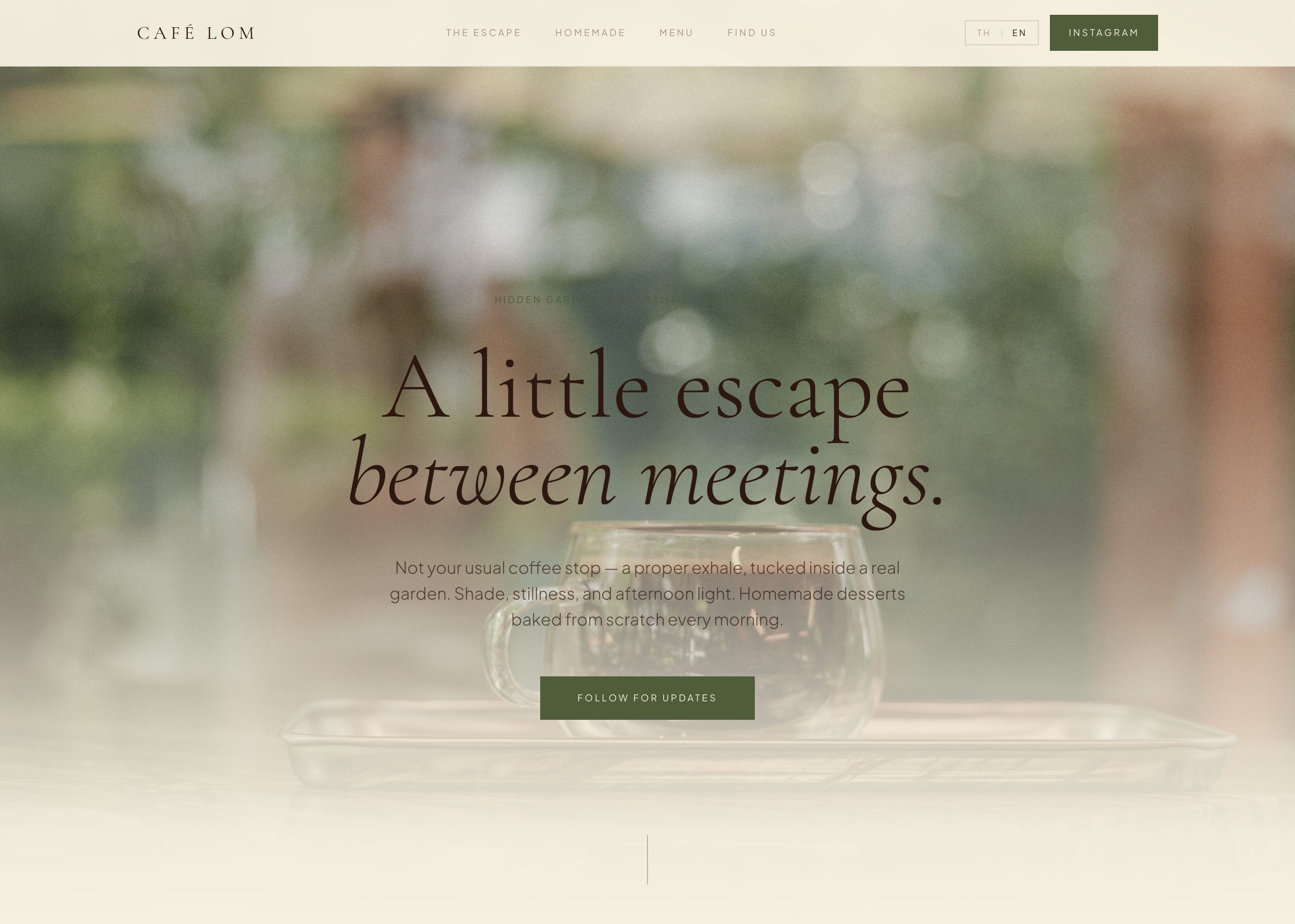 The Café LOM homepage: a full-width photograph of a glass coffee cup in a garden, with the headline “A little escape between meetings.”